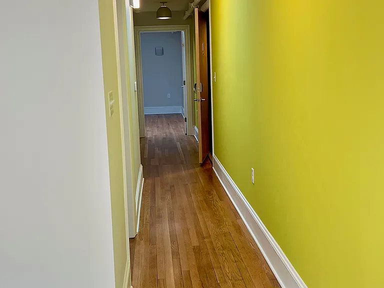Down the interior hall to the bedrooms and front door (slightly open on the right).