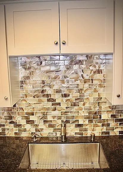 Stainless steel sink, tile back splash.