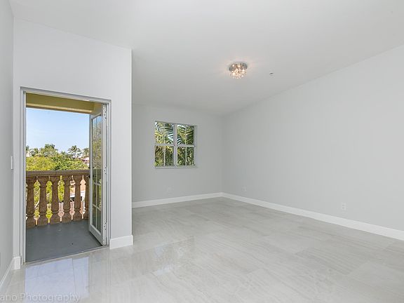 Master Bedroom with Cathedral ceilings and balcony facing Ea