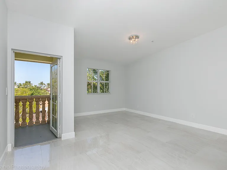 Master Bedroom with Cathedral ceilings and balcony facing Ea
