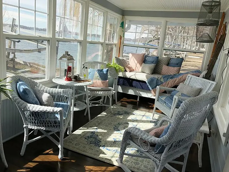Gorgeous front porch with plenty of seating and a day bed. Enjoy your morning coffee while taking in the beautiful lakefront views.