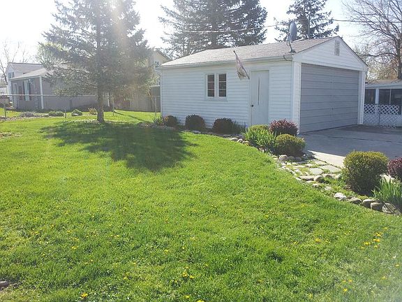 Two car detached garage with concrete approach and large backyard