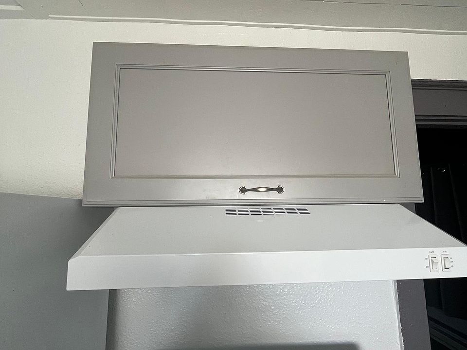 Storage cabinet and exhaust hood above range