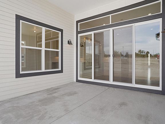 Covered Rear Patio Photo representing home to be built and may demonstrate optional features