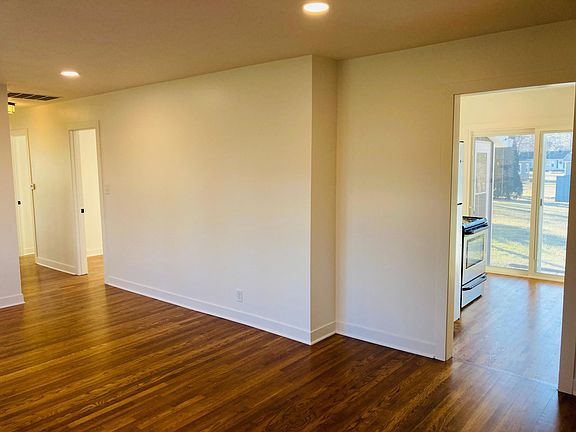 Entrance view from living room into kitchen and hallway.