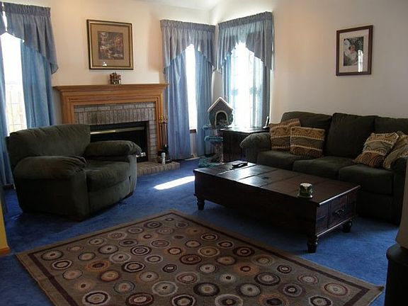 Lovely LR with fireplace, vaulted ceilings, open dramatic staircase to 2nd fl!