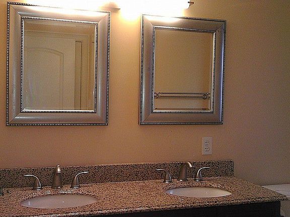 This shot shows the dual sinks in the bathroom. You will love the travertine floor and tub surround.