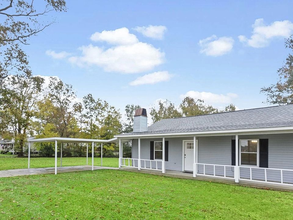 Front, featuring coverage patio and carport