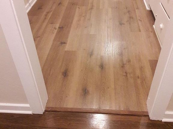 Newly refinished hardwood flooring in Living, Dining Room and Bedroom and closet. New Vinyl wood plank flooring in Kitchen, Laundry and Bath.