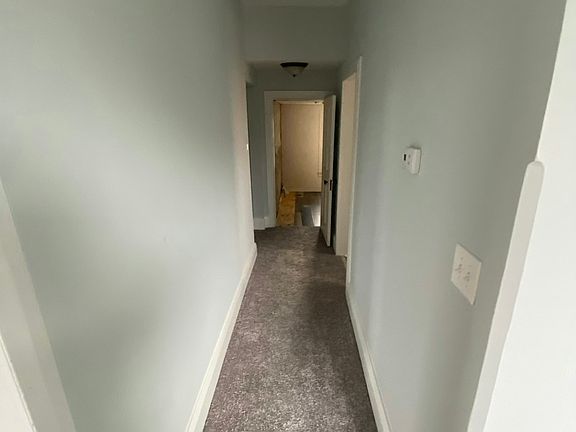 Hall from foyer leading back to bedrooms, dining room, bathroom & kitchen