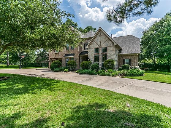 Beautiful front elevation featuring stacked stone and mature landscaping.