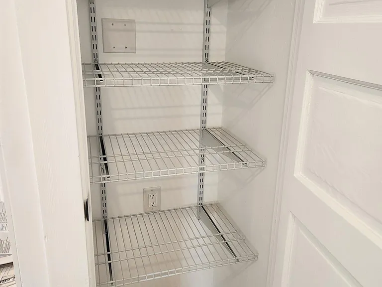 Large pantry provides adjustable shelving.