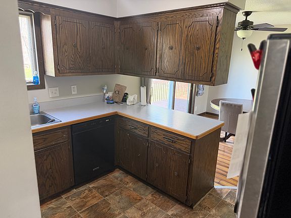 Kitchen with dishwasher, stove, microwave, and refrigerator