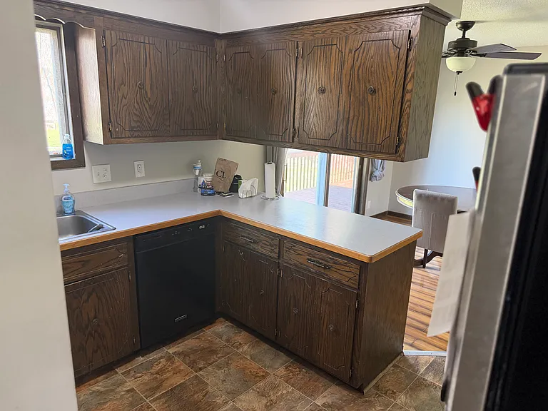 Kitchen with dishwasher, stove, microwave, and refrigerator