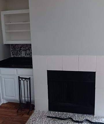 Fireplace and built-in bookcase with granite countertop