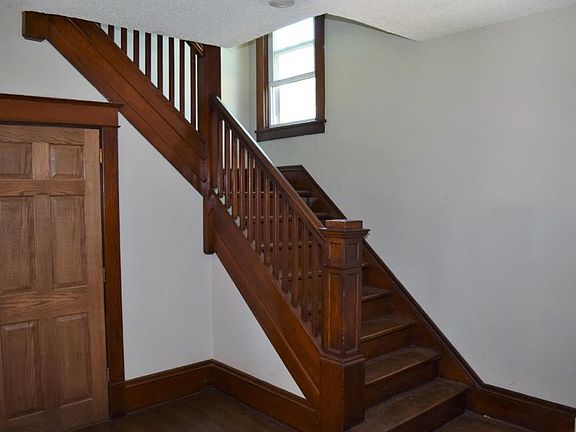 Beautiful woodworking on steps and railing upstairs.