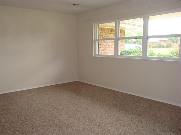 Living room towards front of house. New flooring, paint & windows.