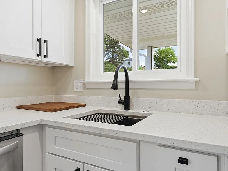 Undermount sink with custom drying rack and cutting board insert.