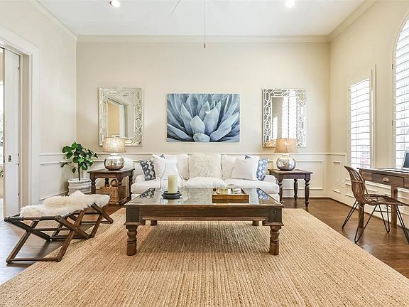 The formal living room at the front of the home provides a serene welcome to your guests - or the prefect place from which to work on your laptop and watch the world go by.