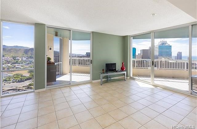 What a beautiful living room to call home.  Floor to ceiling windows, the largest of the 1 bedroom units, in fact, this unit is larger than some of the 2 bedrooms. Views of the ocean, city skyscape, mountains, punchbowl. 2 lanai's allow for open lanai ent