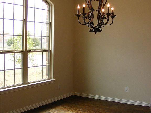 Formal dining room features hardwood floors, and crown molding.
