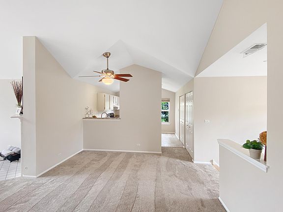 The dining room area (underneath the ceiling fan) has a helpful pass-through from the kitchen.