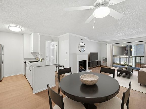 Renovated Package I kitchen, living, and dining area with hard surface flooring