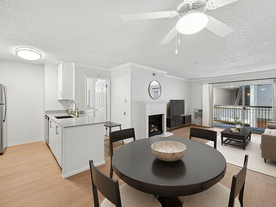 Renovated Package I kitchen, living, and dining area with hard surface flooring