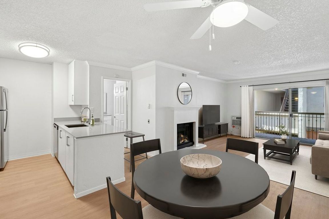 Renovated Package I kitchen, living, and dining area with hard surface flooring