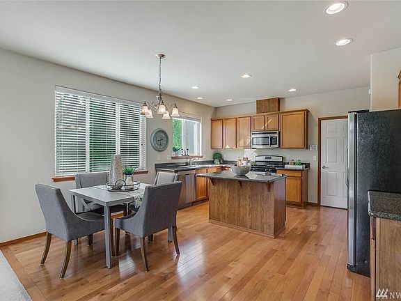 Picture perfect living room opens to a fully fenced backyard.