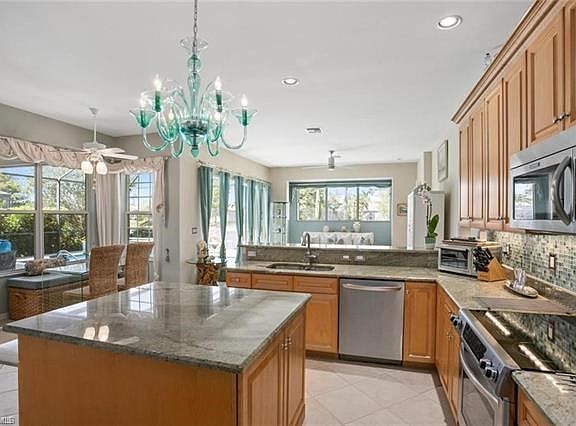 Three walls of glass bring beautiful bright light views into the Great-Room from the immense Kitchen into the Family-Room ... A 