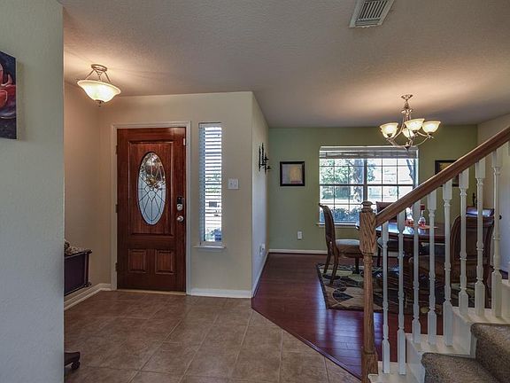 Tiled entry which leads to formal dining room with beautiful wood flooring.