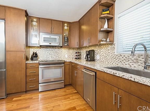 Custom-made maple cabinets and antico bianco granite