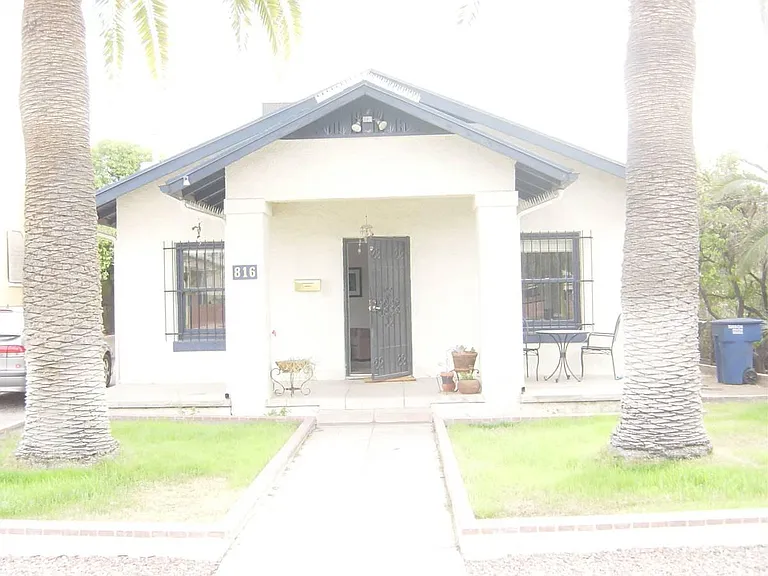 front of house, with rock now instead of grass