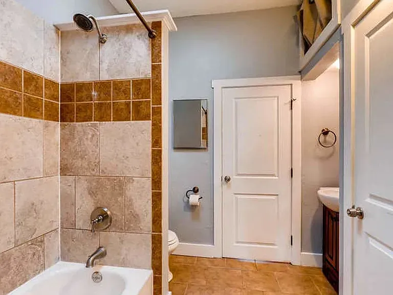 The bathroom has a shower & bathtub - plus a closet and skylight!