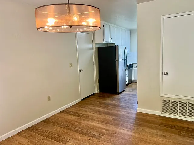 dining area leading to the kitchen. left door is the deep garage allowing some storage, and automatic garage door opener.