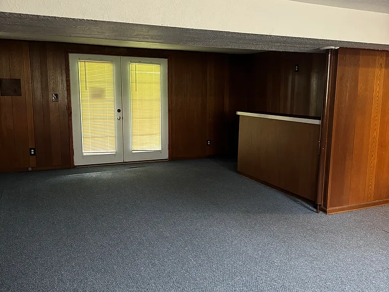 Basement and bar area and doors out to backyard