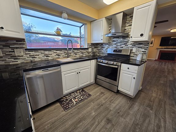Kitchen with Range Oven, Sink & Dishwasher.