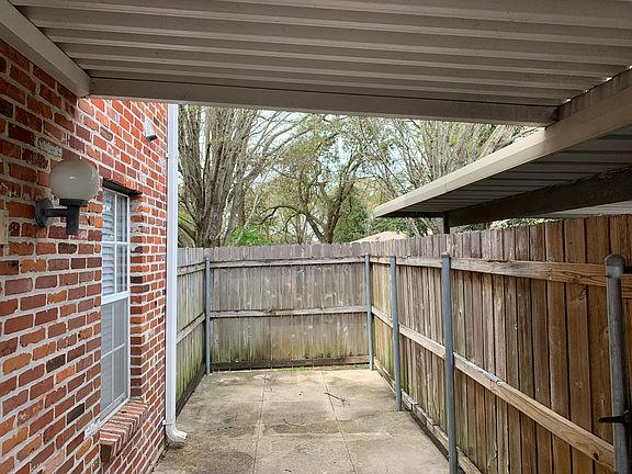 Fenced patio with covered entry