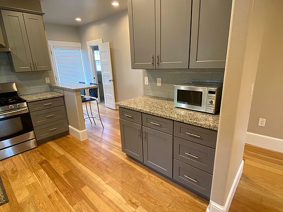 Kitchen looking toward back bathroom and backyard