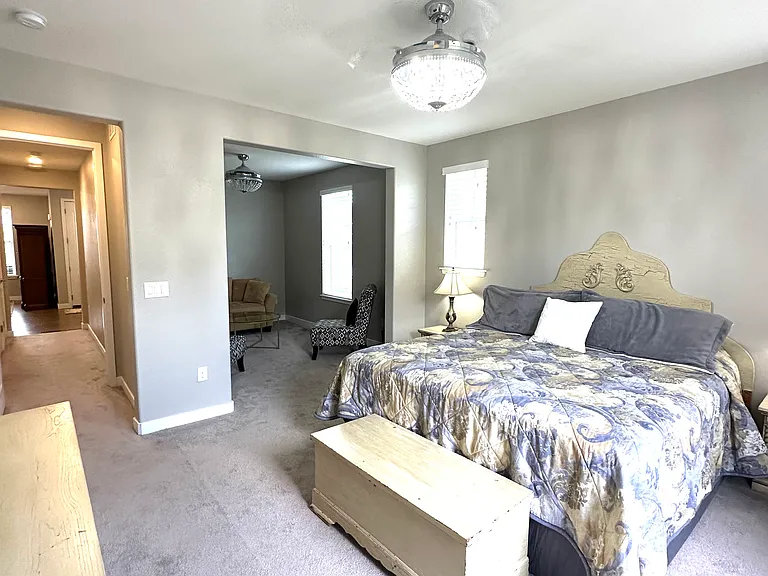 The spacious bedroom offers plenty of room for a king-size bed and additional furnishings, such as dressers, nightstands. Ample lighting creates a bright and comfortable atmosphere, making it a relaxing retreat at the end of the day.