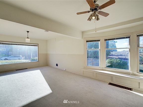 Light & bright living room with bay window looking out towards the Olympic Mountains 