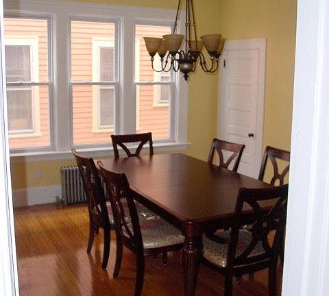 Oversized dining room with mahogany inlaid flooring. Room has a new light fixture and has since been painted a more neutral color.