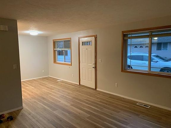 Looking from living room towards front door and dining room