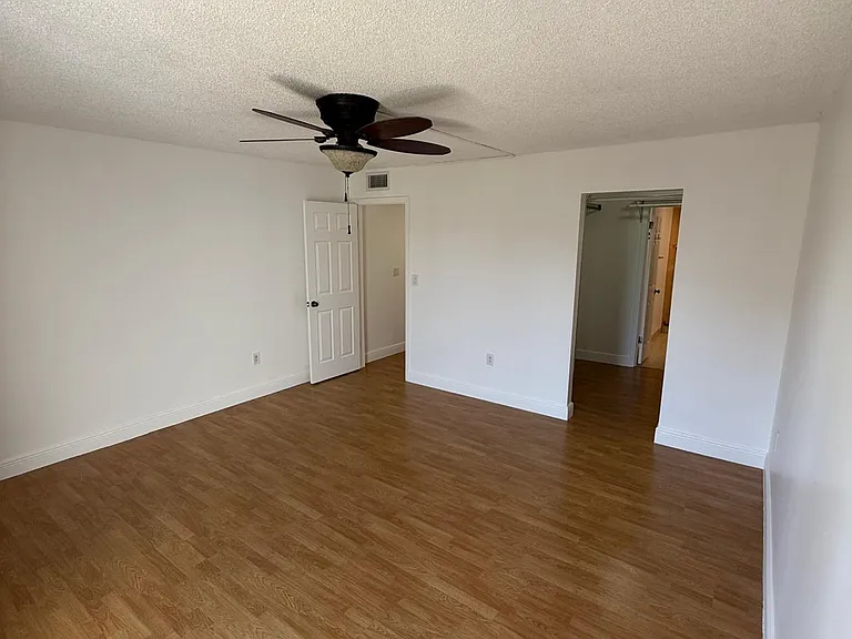 Master bedroom looking into walk in closet and master bathroom