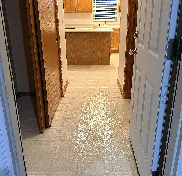 Entry from garage past hall closet into kitchen