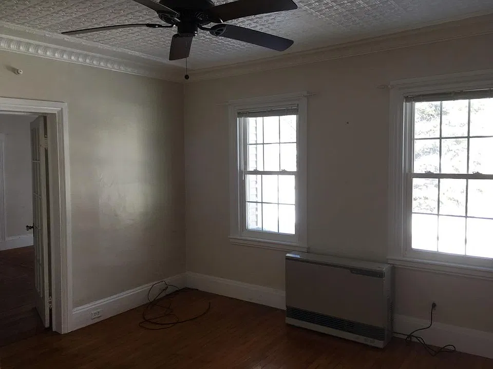 Living/dining room, looking back through door into bedroom.