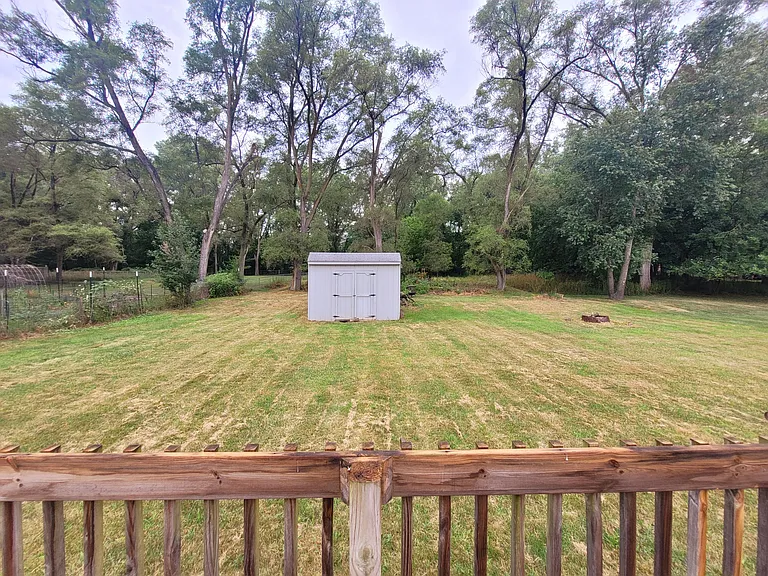 Large back yard with patio and storage shed