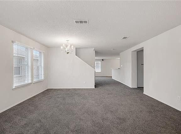 As you walk into the front door, you walk into this huge room featuring a front living room and formal dining room. Off to the right through the door opening you have a huge storage closet, laundry room, door to the garage and the master bedroom. Straig