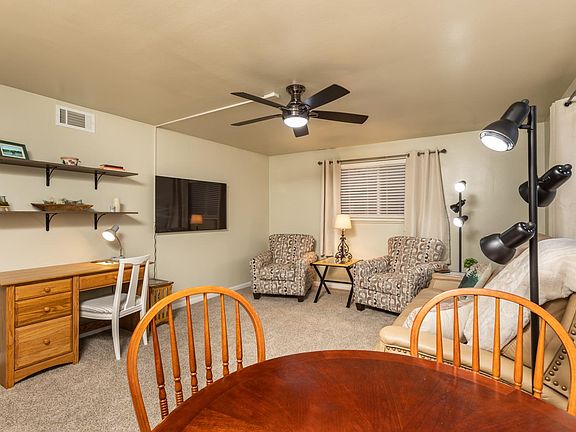 Office desk, two comfortable chairs with reading lamp and smart TV ready for your media.